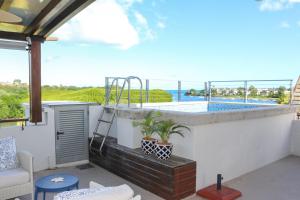 a balcony with a swimming pool on a building at La Balise Marina by Horizon Holidays in Tamarin
