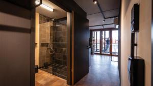 a bathroom with a walk in shower next to a door at Stadthaus Neckarsulm serviced apartments - Stadthaus Heiner in Neckarsulm +33 photos