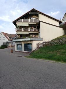 a house with a balcony on the side of a street at Ferienwohnung Martin und Tanja Klumpp in Baiersbronn