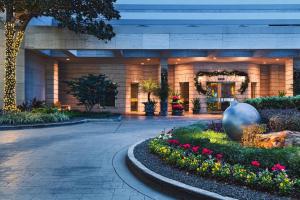 a lobby of a building with flowers in a courtyard at The St. Regis Houston in Houston