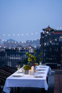 einen Tisch mit Kerzen und Weingläsern auf dem Balkon in der Unterkunft base-Beijing Wangfujing Serviced Apartment in Peking