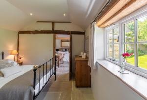 a bedroom with a bed and a window at Hope Cottage - West Sussex in Henfield