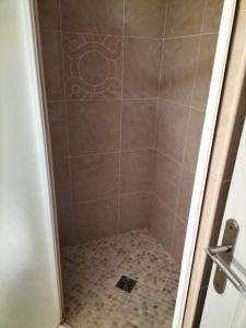 y baño con ducha y suelo de baldosa. en Hotel Restaurant Herard, en Bourbonne-les-Bains