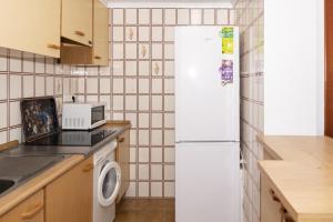 a kitchen with a white refrigerator and a microwave at Florazar 2, Iv-14-C in Cullera