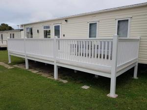 a large white deck on a mobile home at D&A's Short Breaks - St Margarets Bay, Dover in St Margarets at Cliff