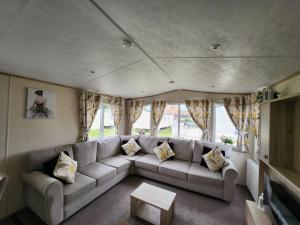 a living room with a couch and a table at D&A's Short Breaks - St Margarets Bay, Dover in St Margarets at Cliff