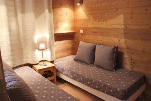 a room with two beds in a wooden room at Eskival Appartements VTI in Val Thorens