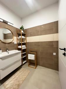 a bathroom with a sink and a mirror at Apartmány Kamenec in Zákamenné