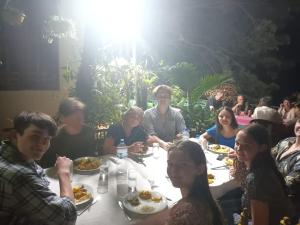 a group of people sitting around a table eating food at Green Garden Homestay in Giritale