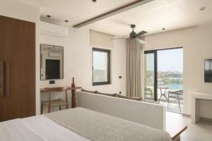 a bedroom with a bed and a large window at Irida Hotel Agia Pelagia in Agia Pelagia