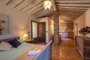 a bedroom with a bed and a kitchen in a room at Croce di mezzo in Montalcino