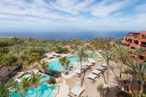 an aerial view of a resort with palm trees and a pool at The Ritz-Carlton Tenerife, Abama in Guía de Isora