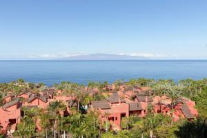 a view of a resort town with palm trees and the ocean at The Ritz-Carlton Tenerife, Abama in Guía de Isora