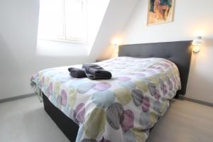 a bedroom with a bed with a polka dot blanket at PEBE ART - COLMAR City center in Colmar