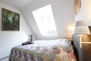 a bedroom with a bed and a window at PEBE ART - COLMAR City center in Colmar