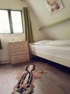 a room with a bed and a stuffed animal on the floor at The Green Apple Durbuy in Durbuy