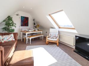 a living room with a couch and a table at 18 The Old Corn Exchange in Berwick-Upon-Tweed