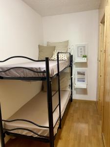 a couple of bunk beds in a room at La Finestra sul Brenta with FREE AND PRIVATE CAR PARK IN MAD di CAMPIGLIO CIPAT O22233-AT-O13262 in Folgarida
