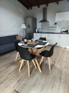 a table and chairs in a living room with a kitchen at House to relax El Tanque in Tanque