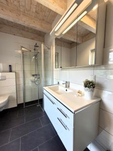 a bathroom with a sink and a shower at Winterberg Chalet 21096 in Winterberg +26 photos