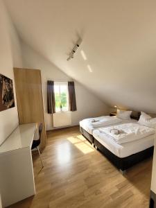 a bedroom with a large bed and a desk at Winterberg Chalet 21096 in Winterberg
