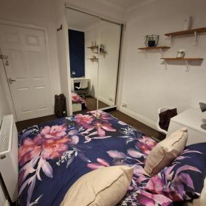 a bedroom with a bed with a flower pattern on it at Double room in Heaton in Heaton