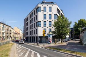 un edificio blanco al lado de una calle en Deluxe Apartment Podskale 18 with Parking & Balcony in Kraków by Renters Prestige en Cracovia