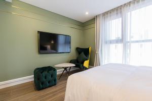 Un pat sau paturi într-o cameră la HOTEL THE MAY Jongno