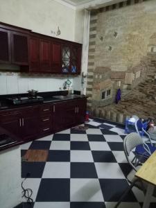 a kitchen with a black and white checkered floor at 3BT home in Hanoi