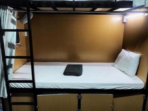a bunk bed with a black briefcase sitting on it at 3BT home in Hanoi