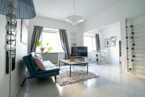 a living room with a blue chair and a table at Stylish Studio at the Heart of Helsinki in Helsinki