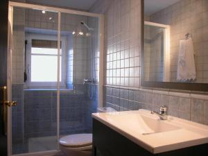 a bathroom with a sink and a toilet and a shower at Casa de la Martina in Molinos de Duero +4 photos