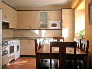 a kitchen with a wooden table and a microwave at Casa de la Martina in Molinos de Duero