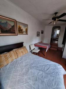 a bedroom with a bed and a table in it at The Budget Inn in Bloemfontein