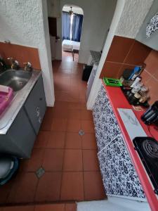 a kitchen with a sink and a red counter top at The Budget Inn in Bloemfontein