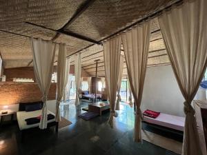 a room with two beds and curtains in it at Villas in Wellness Centre with Sauna in Arambol