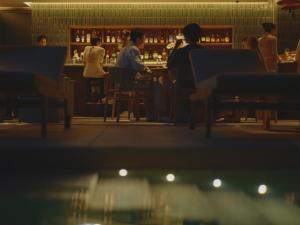 a group of people sitting at a table in a restaurant at TRUNK(HOTEL) YOYOGI PARK in Tokyo