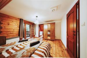 a bedroom with a bed and a wooden wall at Cabin Sonka in Oščadnica