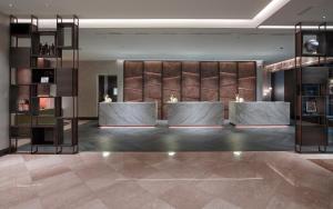 a lobby of a building with a display case at Hilton Milan in Milan