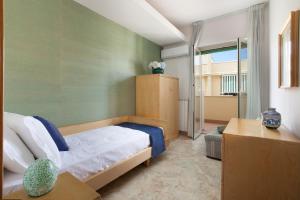 a bedroom with a bed and a room with a window at New Family 3 Bedrooms house in Sorrento in Sorrento
