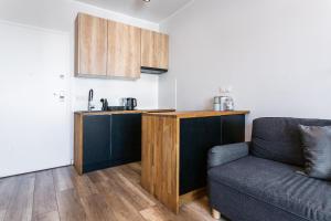 a living room with a couch and a kitchen at Apartament Yana 35 Warsaw in Warsaw