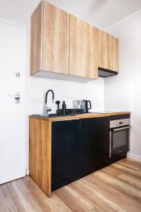a kitchen with a black and wooden counter top at Apartament Yana 35 Warsaw in Warsaw