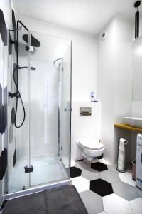 a bathroom with a toilet and a glass shower at Apartament Yana 35 Warsaw in Warsaw