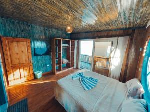 a bedroom with a bed in a room with a balcony at New Moon Island Camp in Nuweiba +181 photos