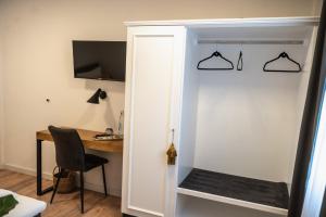 a room with a desk and a door with a chair at Hotel Kavala in Lohmar
