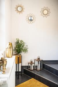 a black and white living room with black stairs and mirrors at Hotel Kavala in Lohmar