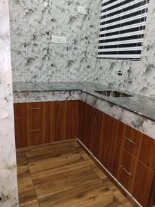 a kitchen with a sink and a counter top at Mary Land Homestay in Trivandrum