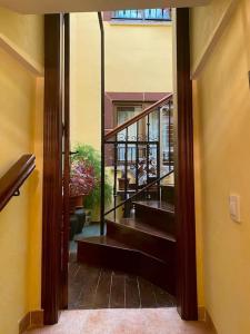 an open door to a hallway with stairs in a house at La herradura, acogedora casa en Montemayor del Río in Montemayor del Río