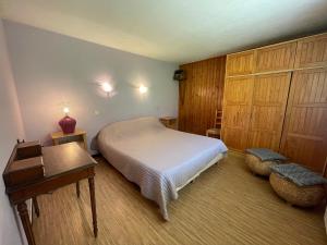a bedroom with a bed and a table and a desk at Ty Menez 1 - Appartement sur les pistes in La Clusaz