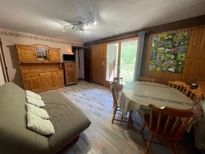 a living room with a table and a couch at Ty Menez 1 - Appartement sur les pistes in La Clusaz